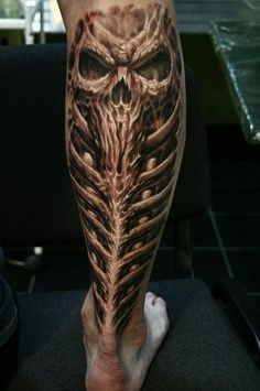 a man's leg with an owl tattoo on it