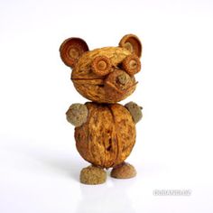 a toy mouse made out of walnuts on a white background with the caption