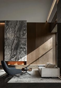 an elegant living room with marble walls and flooring, along with a modern chair