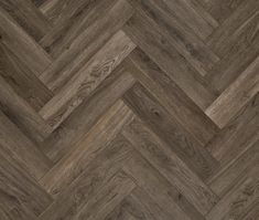 an image of wood flooring that looks like chevroned herringbones in grey tones