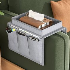 a couch with a laptop and pen holder attached to the back of it's seat