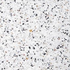 a white background with black and brown speckles on the surface is shown in this image