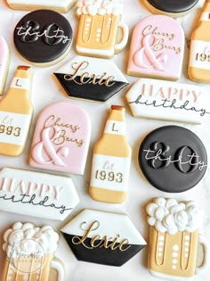 decorated cookies are arranged on a white surface