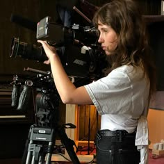 a woman standing in front of a camera