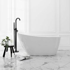 a white bath tub sitting on top of a marble floor