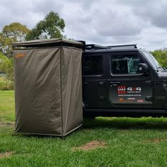 a black truck with a tent on the back