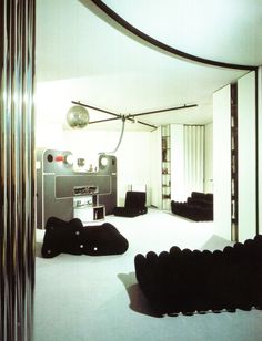 a living room filled with lots of black furniture