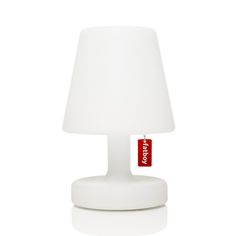 a white table lamp with a red tag on it