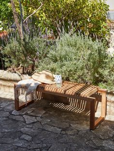 a wooden bench sitting in the middle of a garden