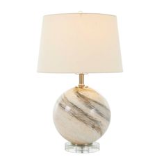 a marble lamp with a white shade on it