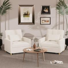 a living room with two white chairs and a coffee table