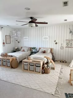 two twin beds in a bedroom with white walls and striped wallpaper on the walls