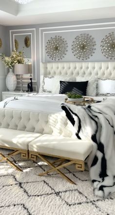 a white bed sitting in a bedroom on top of a rug