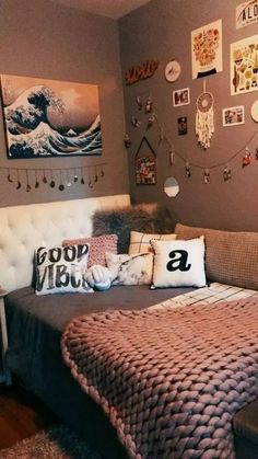 a bed sitting in a bedroom next to a wall filled with pictures and other items