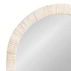 a white round mirror on a white wall