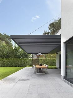 an outdoor dining area with table and chairs