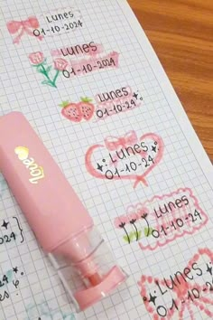 a pink pen sitting on top of a piece of paper with some writing on it