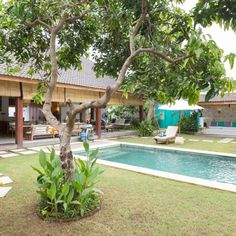 an outdoor swimming pool surrounded by grass and trees