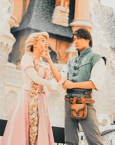 a man and woman dressed up as disney characters