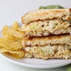 two sandwiches stacked on top of each other with chips