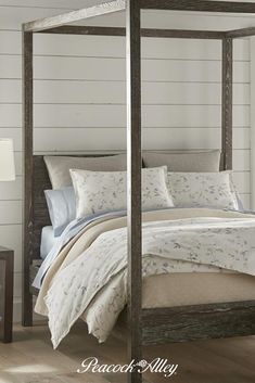 a four poster bed in a bedroom with white walls