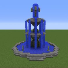 a large blue tower sitting on top of a green field