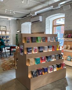 the bookshelf is made out of wood and has many different types of books on it