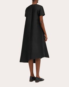 Made for the minimalist, the Doma dress is crafted from a technical silk blend for lustrous appeal. The dramatic A-line silhouette is finished with a slanted hem to create an asymmetric draped effect. Back keyhole clasp closure Asymmetric hem 86% polyester, 14% silk Dry clean Made in Romania Size & Fit Size EU 32 (US 0 / XXS): 31.5in bust, 24.02in waist, 34.25in hips, 14.33in shoulder width Size EU 34 (US 2 / XS): 33.07in bust, 25.59in waist, 35.83in hips, 14.72in shoulder width Size EU 36 (US 4 Tan Woman, Black Midi Dress, Asymmetric Hem, A Line, Dry Clean, Midi Dress, Silk, Black