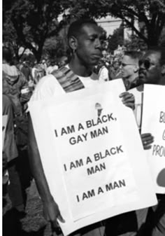 two black men holding signs in front of them