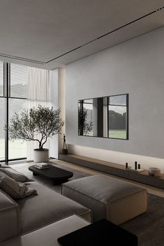 a modern living room with large windows and a tree in the center, is shown