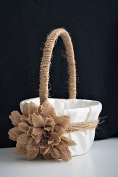 a white basket with a flower on it