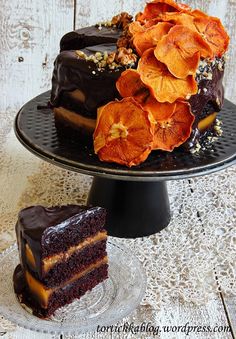 there is a chocolate cake with orange flowers on the top and one slice has been cut