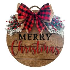 a merry christmas sign hanging from the side of a wooden plaque with red and black plaid bow