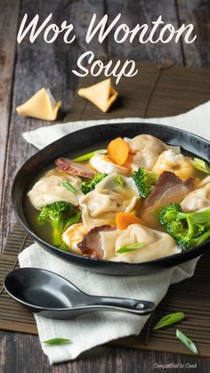 a bowl of wonton soup with broccoli, carrots and meat in it