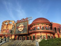 a large building with stairs leading up to it and a sign that says hard rock cafe