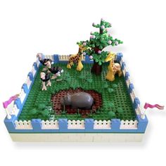 a lego model of a zoo with animals and people