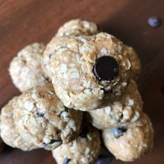 a pile of oatmeal cookies on top of a wooden table