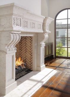 a fireplace in a living room next to a large window