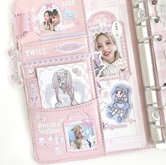 a pink planner with pictures and stickers on it