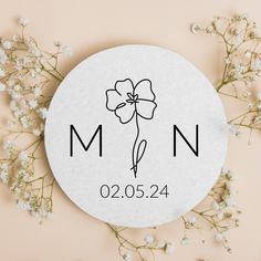 a white round sticker with the word man on it and a flower next to it