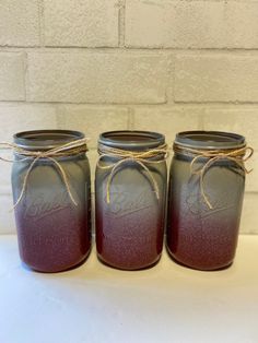 three mason jars tied together with twine