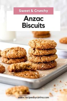 anzac biscuits stacked on top of each other in front of a glass of milk and cookies