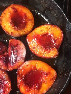 four pieces of fruit are cooking in a skillet