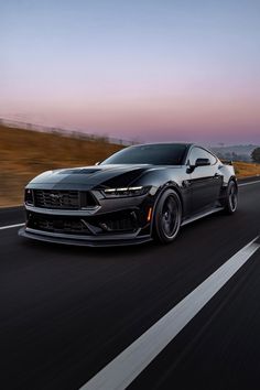 the chevrolet camaro zr1 is driving down the road at sunset or dawn