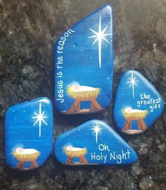 three painted rocks depicting the birth of jesus and an image of a nativity scene