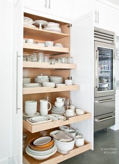 the shelves in this kitchen are full of dishes