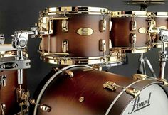 a close up of a set of drums on a black background with gold trimmings