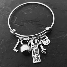 a black and white photo of a silver bracelet with the words strong enough on it