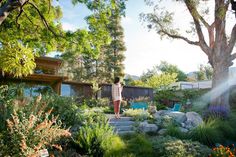 a woman standing in the middle of a garden