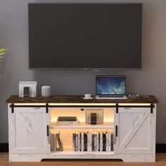 an entertainment center with a flat screen tv and bookshelves in front of it